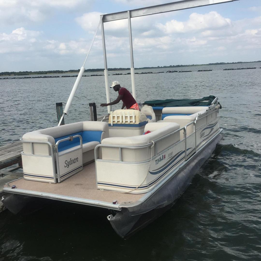 Blue pontoon boat rental in the water at Lake Lewisville