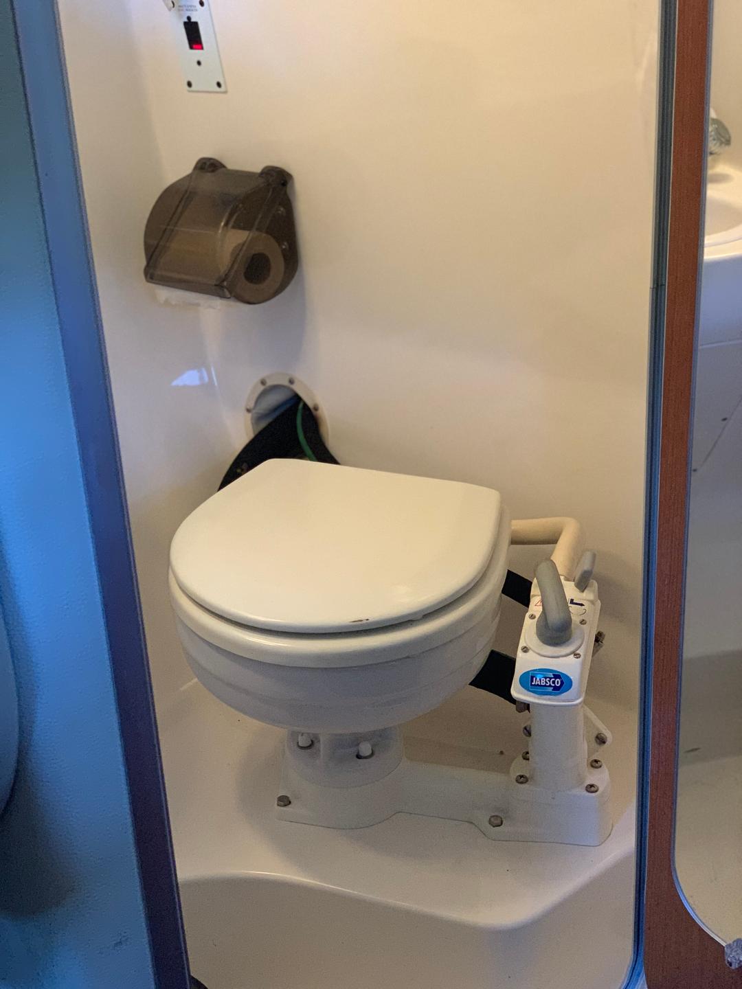 Toilet inside the white mini yacht cruiser boat rental at Lake Lewisville